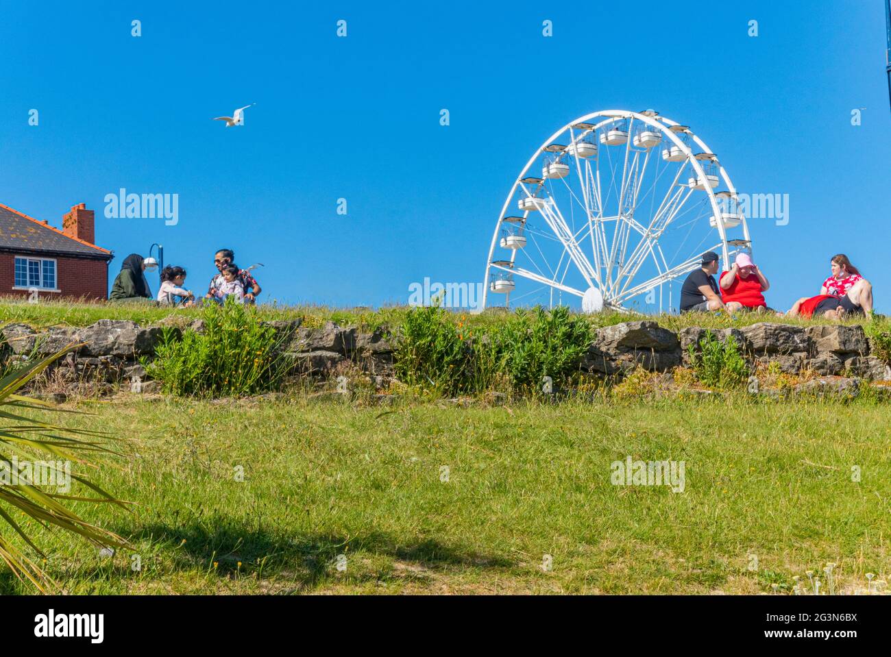 Families enjoying a day out a Barry Island Beach resort, South Wales