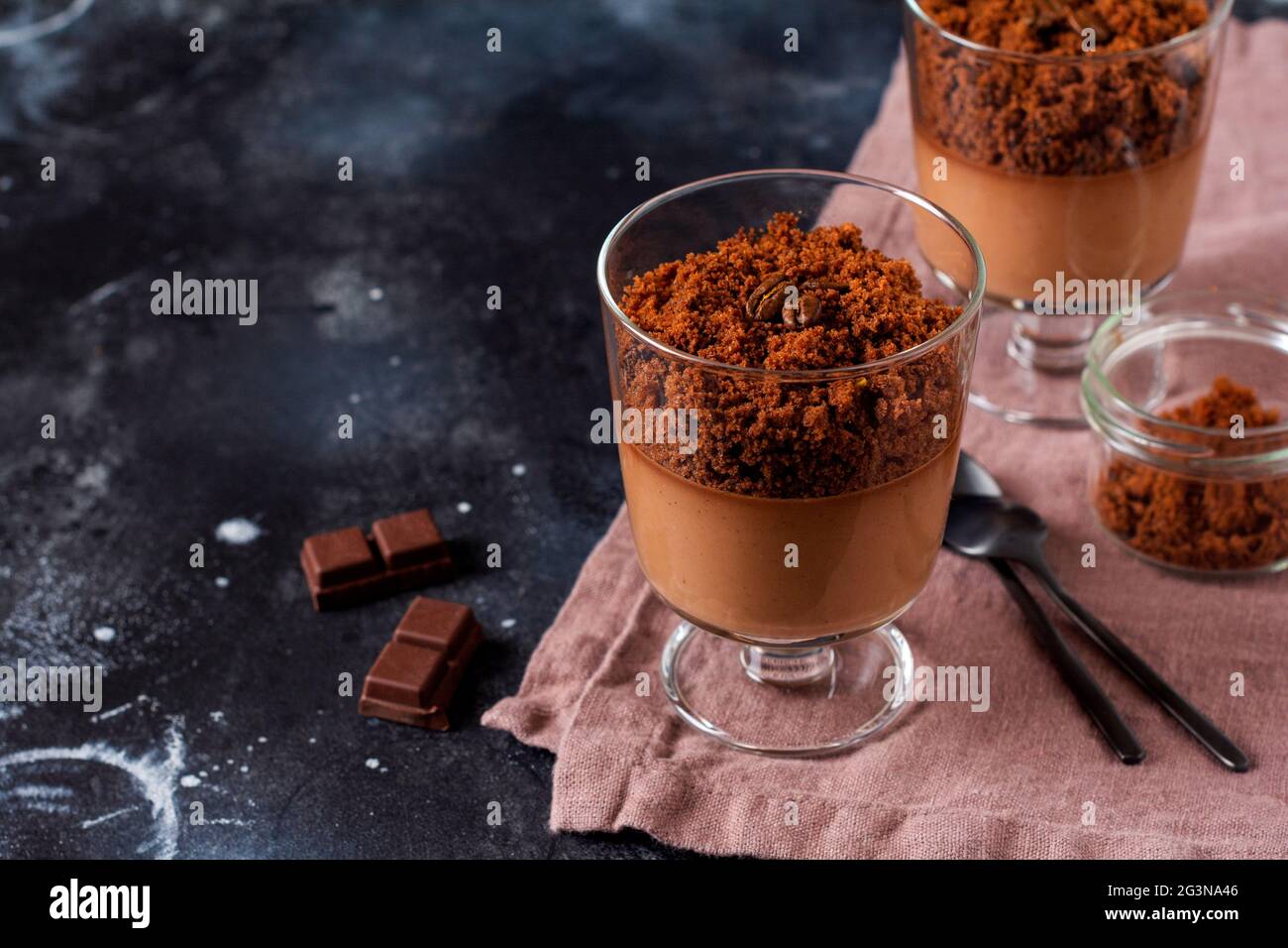Delicious dessert chocolate mousse with brownie in glass jars on a light  slate, stone or concrete background. Selective focus Stock Photo - Alamy