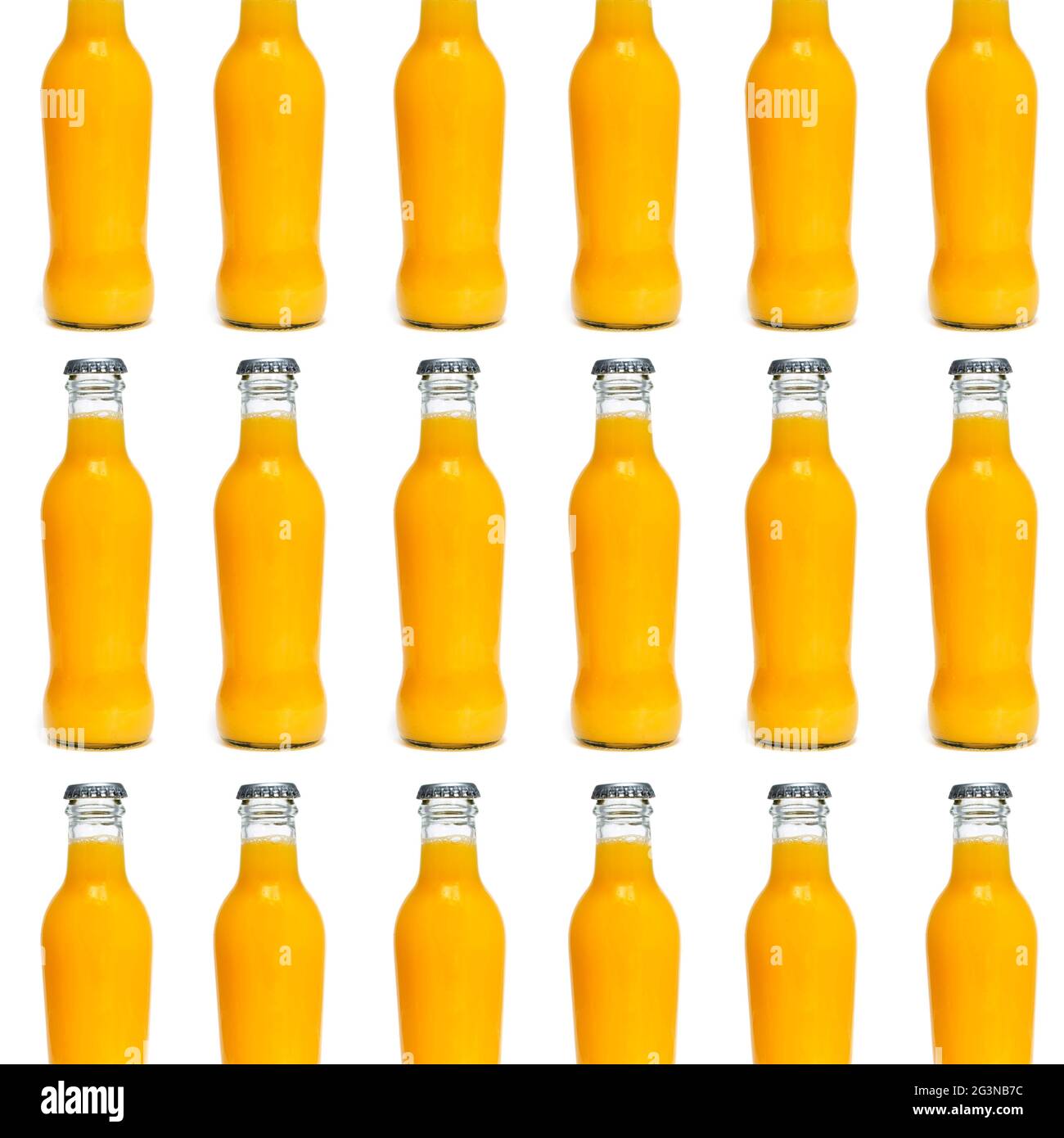 some glass bottles filled with an orange-colored fruit and vegetable beverage arranged in lines forming a mosaic on a white background Stock Photo