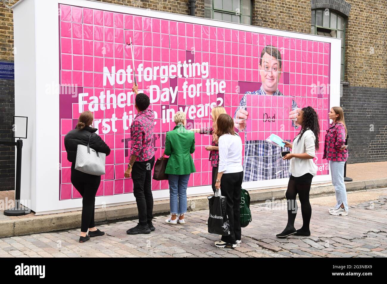 EDITORIAL USE ONLY A 6m x 3m size billboard is unveiled by Plusnet as part of their ÔThatÕll DoÕ campaign, to celebrate FatherÕs Day, featuring free cards for members of the public to take and give to their dads, in Shoreditch, London. Picture date: Thursday June 17, 2021. Stock Photo