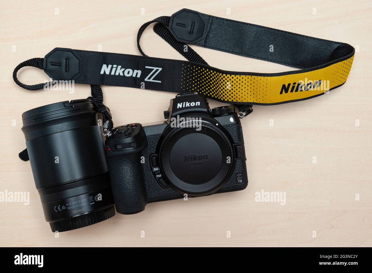 Nikon Z 7II mirrorless digital camera body with neck strap and lens Nikkor Z  85mm f1.8 S. Isolated on wooden background. Top view Stock Photo - Alamy