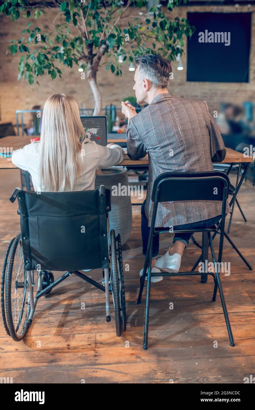 Back view woman in wheelchair hi-res stock photography and images - Alamy