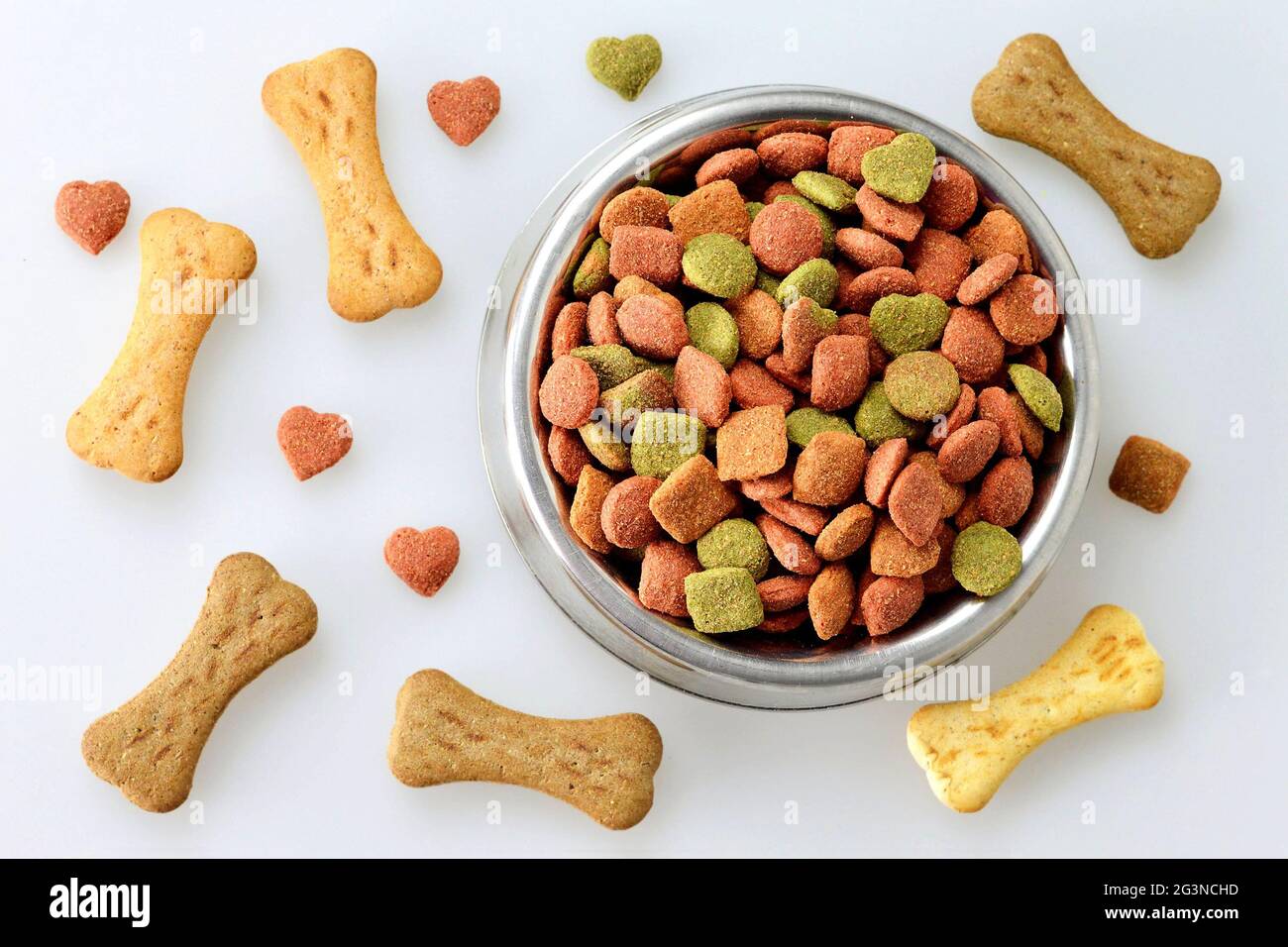 Dog food in the bowl and bone shaped biscuits Stock Photo