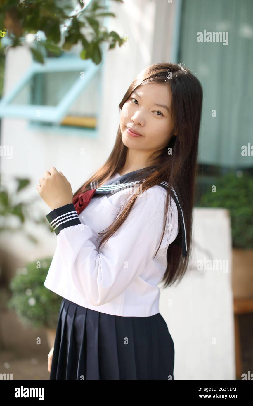 Japanese school girl in local coffee shop Stock Photo