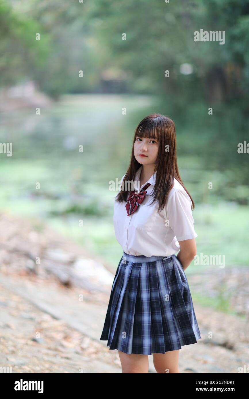 beautiful asian japanese school girl uniform looking at park outdoor