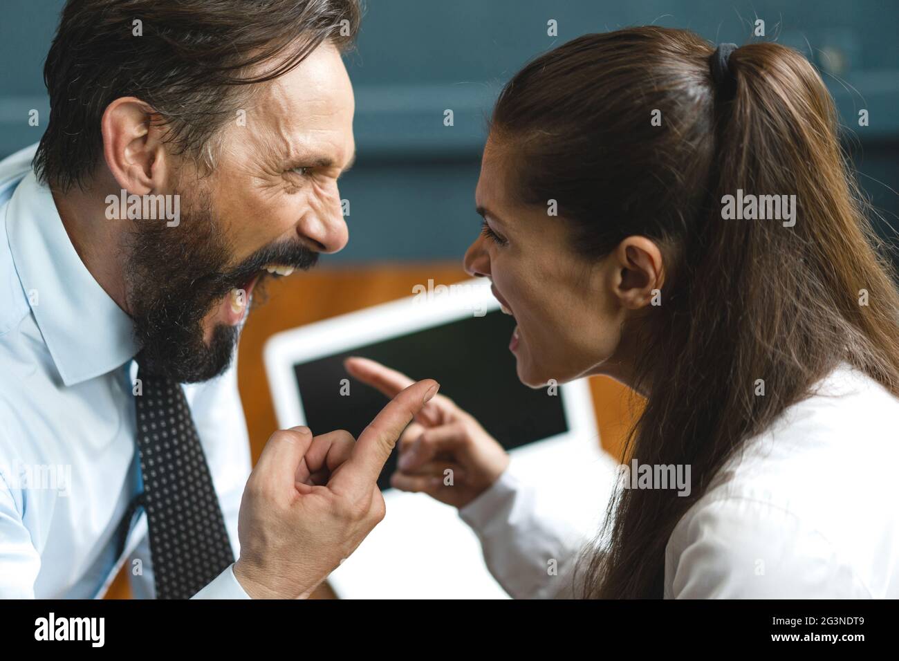 Business colleagues argue and yell at each other Stock Photo