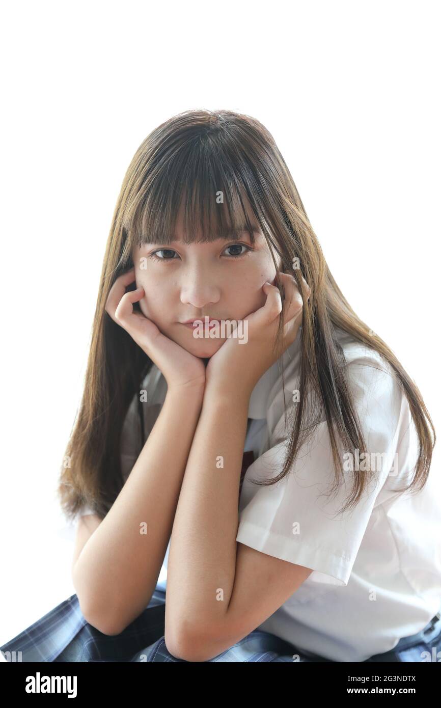 Portrait japanese school girl uniform sitting and look at camera in white  tone bed room Stock Photo - Alamy