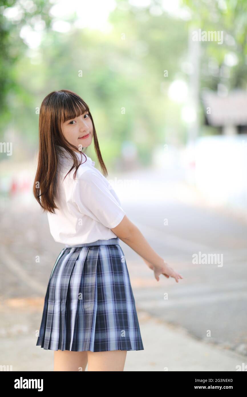 beautiful asian japanese school girl uniform looking at park outdoor ...
