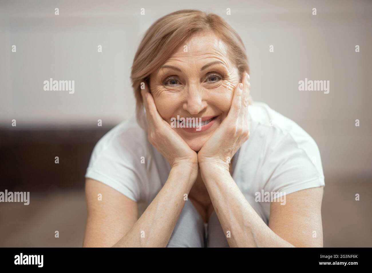 Close Up of a Smiling Woman Over 50 Finished Yoga Exercise. Stock Photo