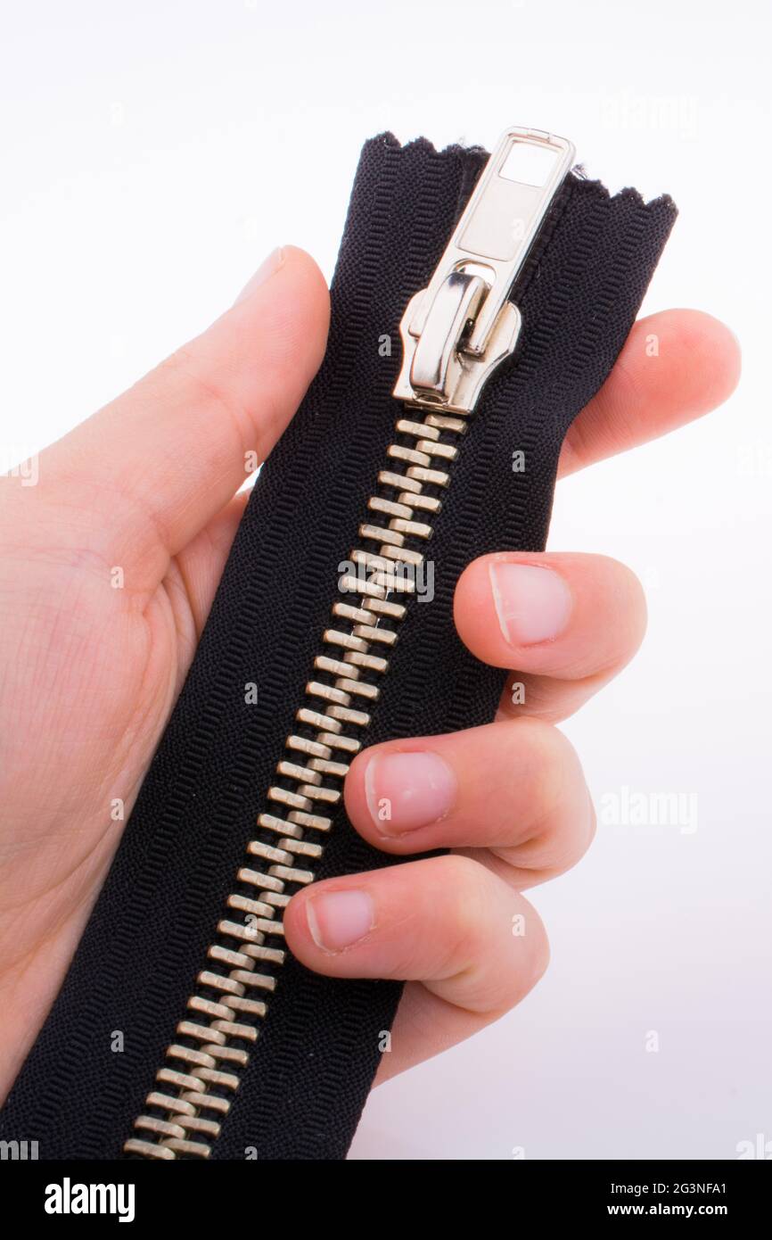 Hand holding zipper Stock Photo