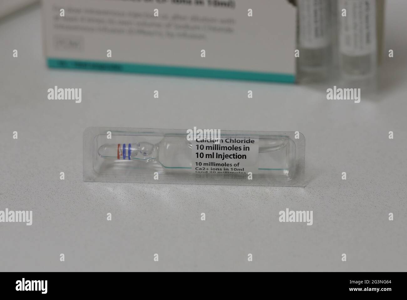 an Ampoule of Calcium Chloride (CaCl₂) injection in front of its box Stock Photo
