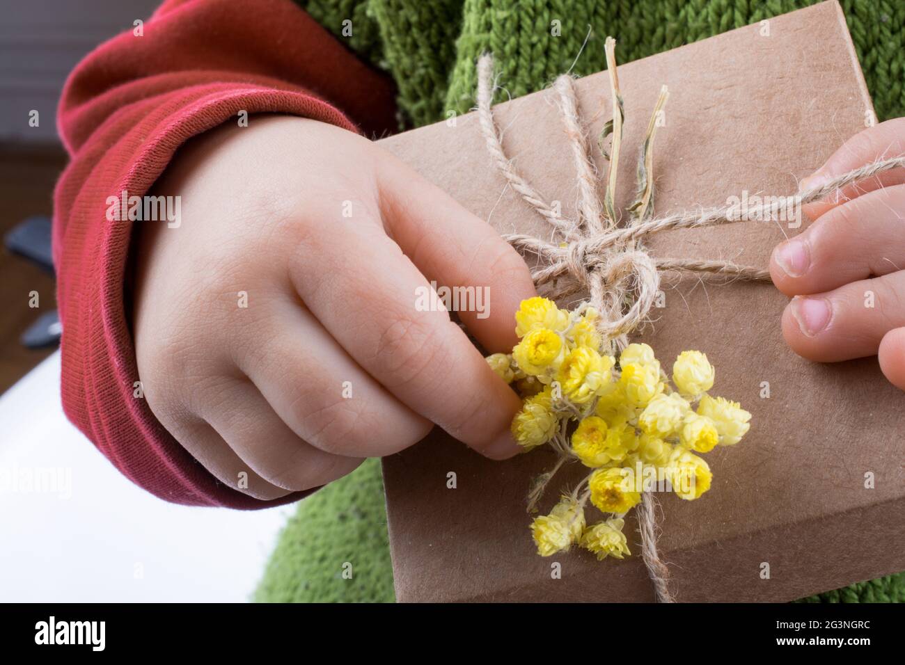 Gift Box with Flowers in hand Stock Photo