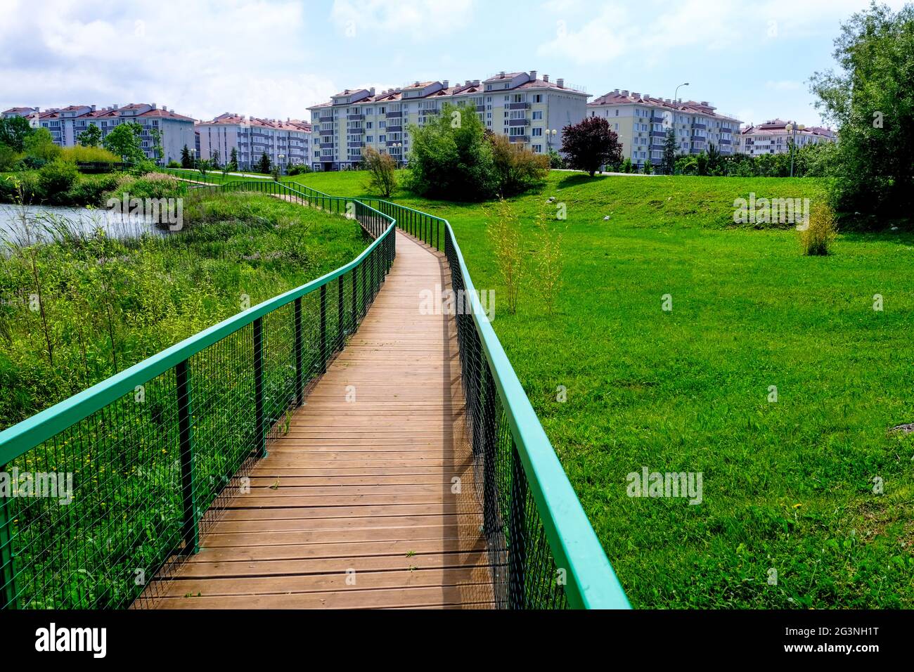 wooden walkway located in the park along the lakeshore . Stock Photo