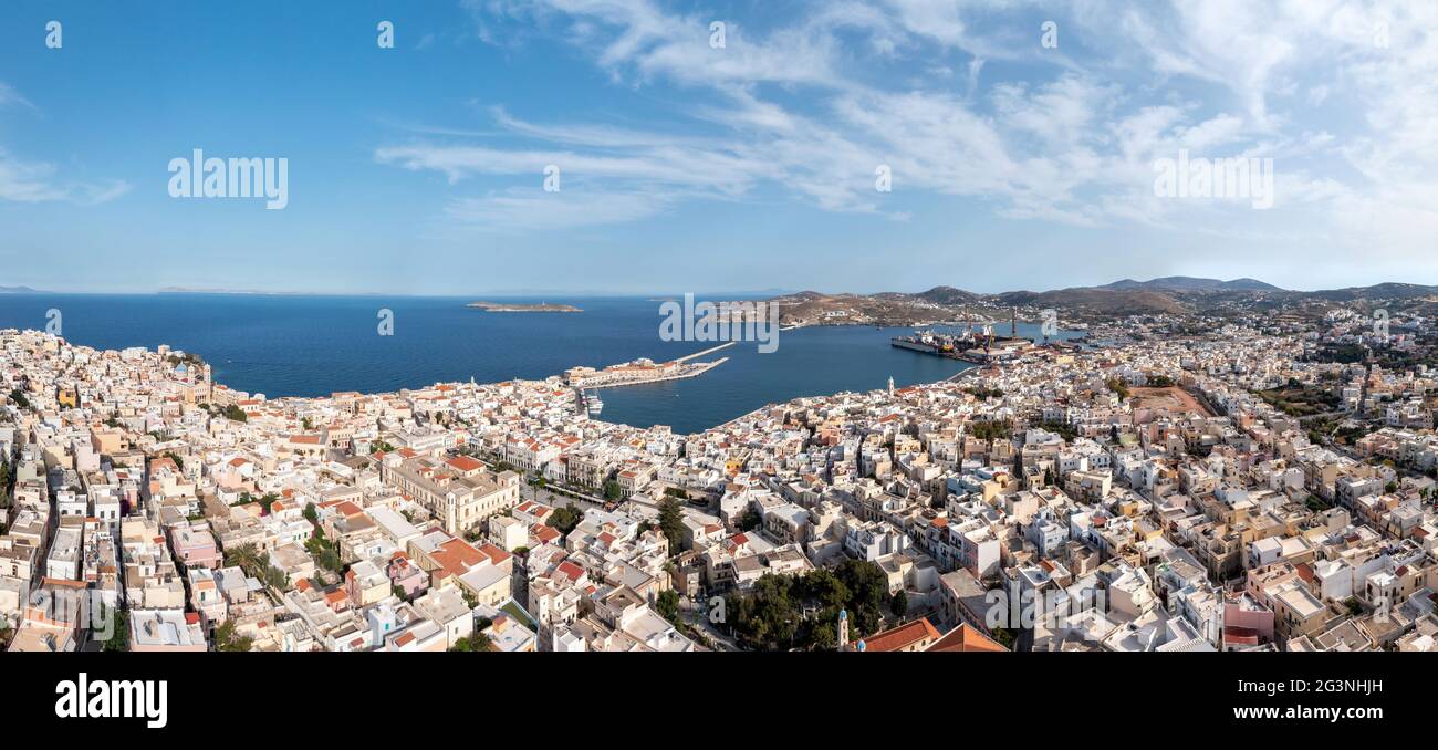 Syros island, Greece, Cyclades capital Ermoupolis cityscape panorama, Siros or Syra town and Neorion shipyard panoramic aerial drone view, calm sea, c Stock Photo
