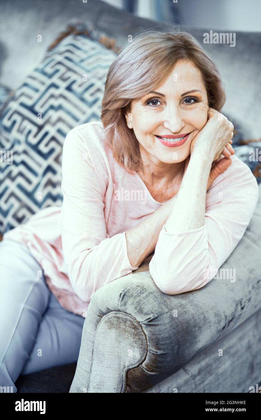 Beautiful mature woman gently smiles at camera Stock Photo