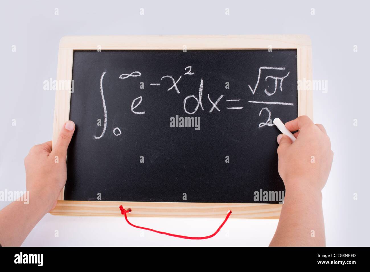 Hand writing a math problem on board Stock Photo