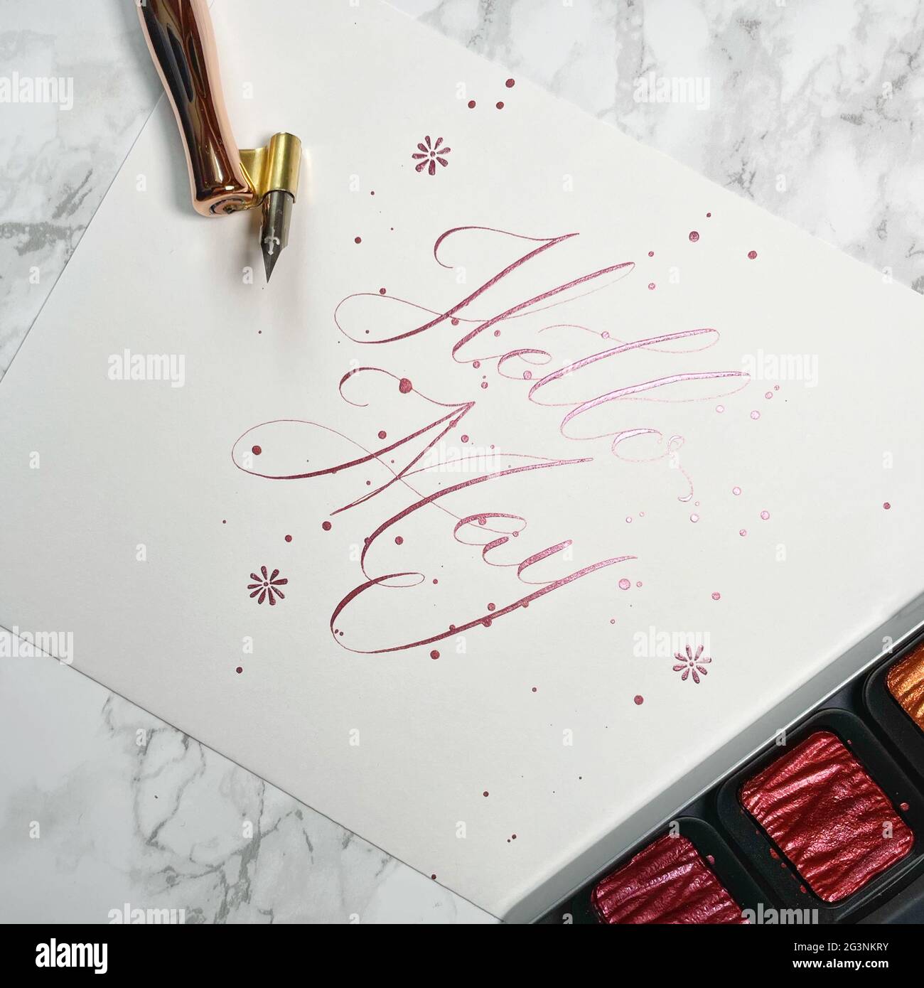 Hello May - flourishing copperplate calligraphy with pointed pen Stock Photo