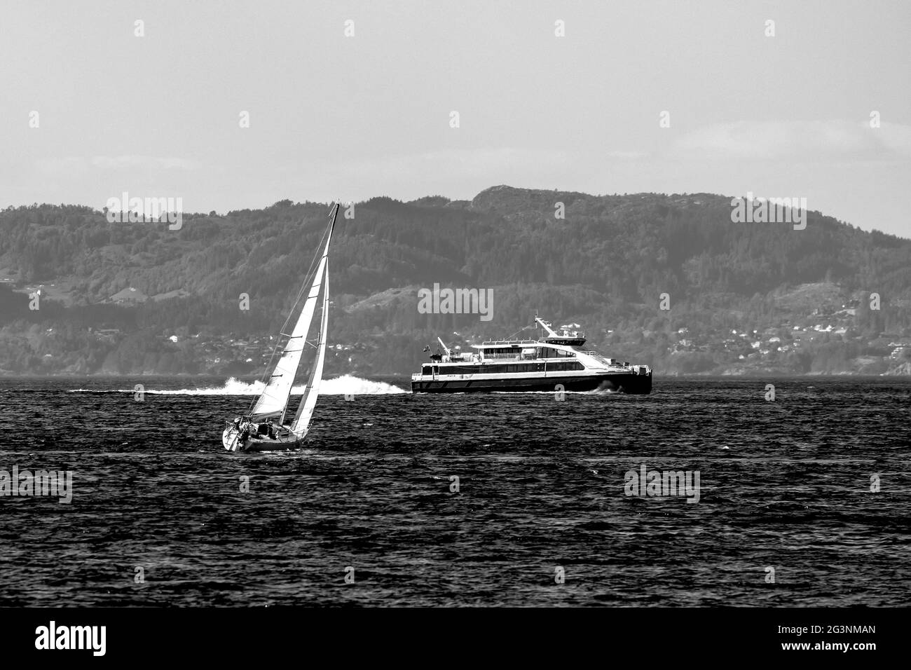 Sail boat Schmelnick in Byfjorden, Bergen, Norway. Local high speed catamaran Ekspressen in background Stock Photo
