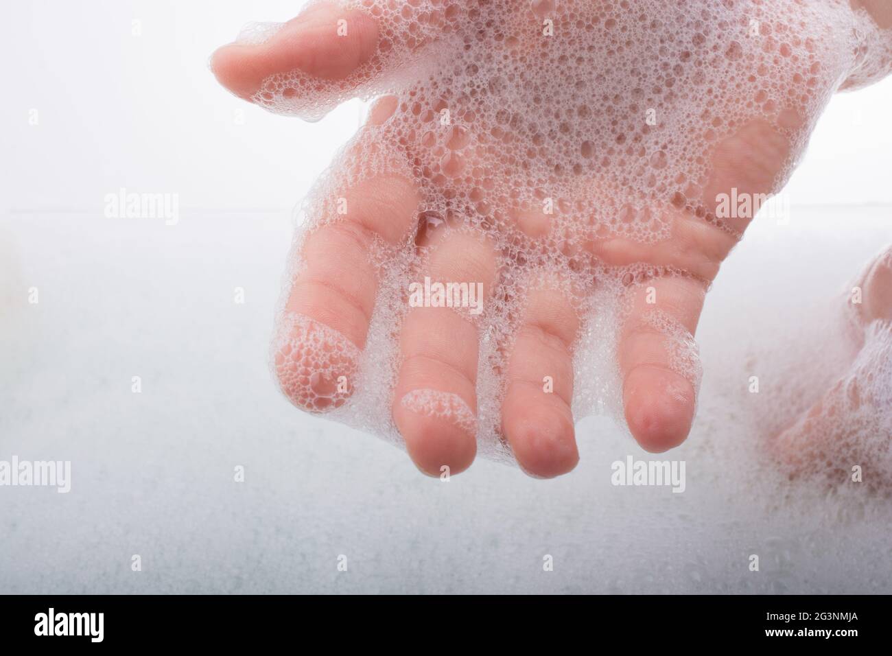 Child washing hands in foam Stock Photo Alamy
