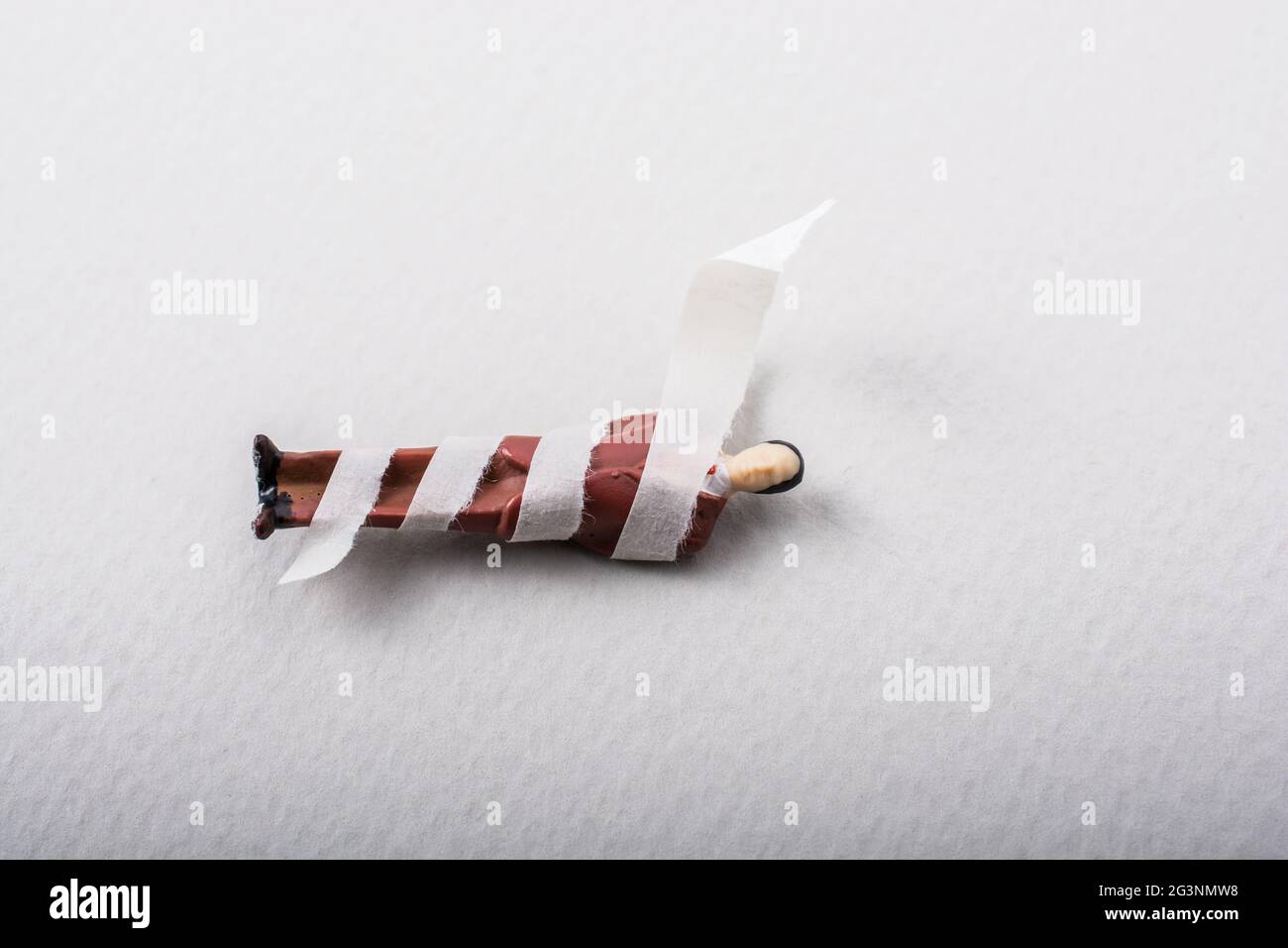 Tiny figurine of man model  wrapped in bandages Stock Photo