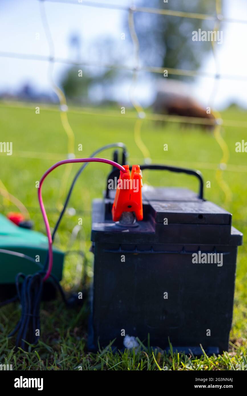 Electric fence with an electrical transformer and battery power pack in