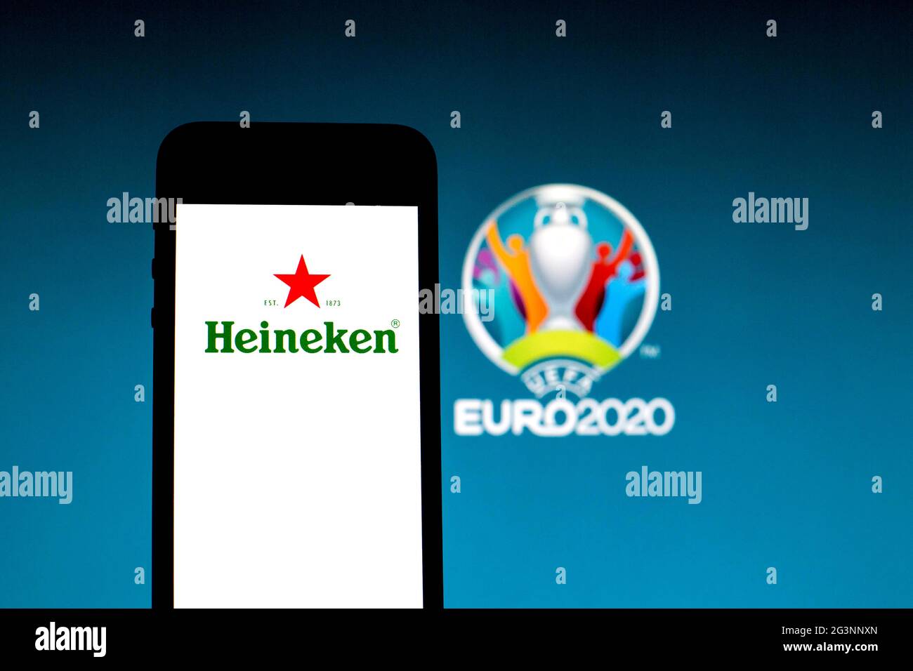 In this photo illustration a Heineken logo seen displayed on a smartphone with a UEFA Euro 2020 logo in the background. Stock Photo