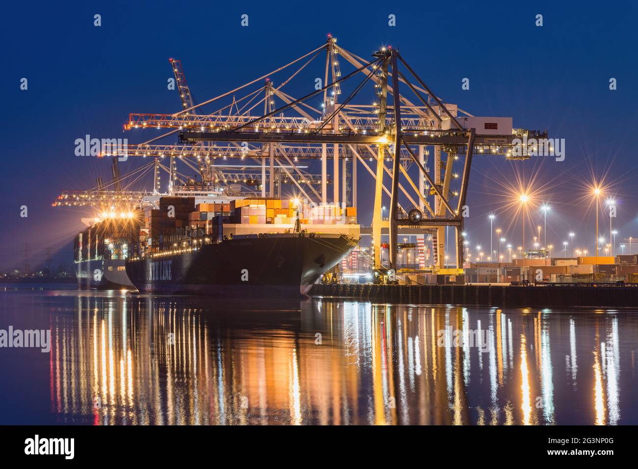 A night view of container ships loading at the DP World facility at the ...