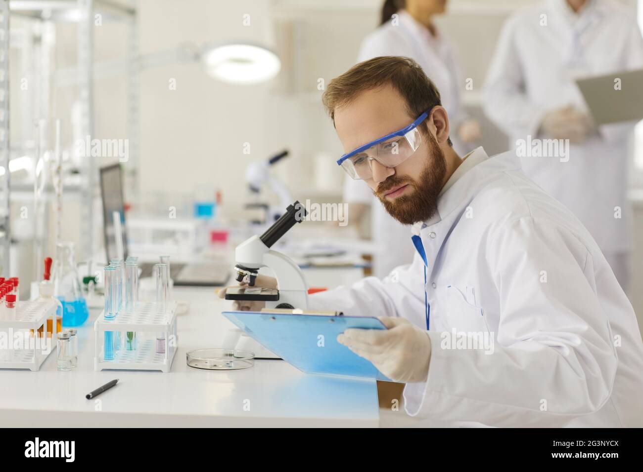 Medical male pharmacy scientist working in laboratory with test sample Stock Photo