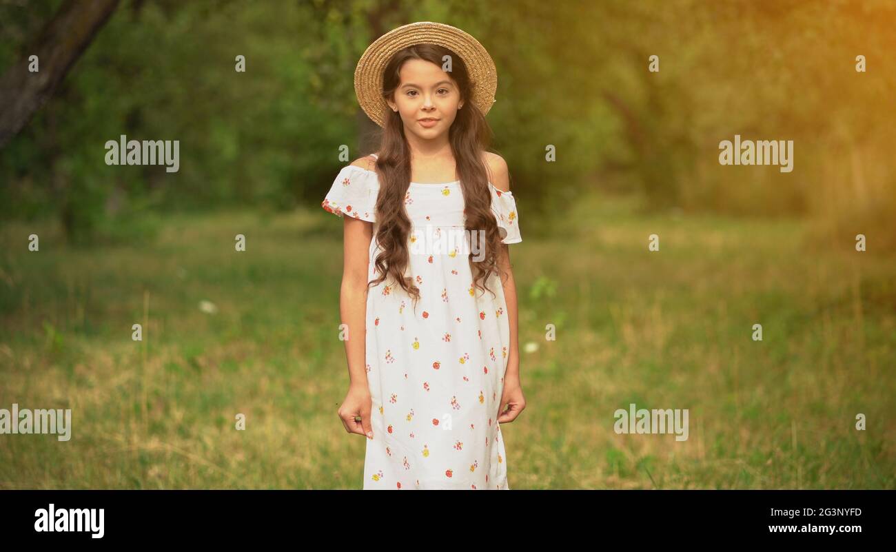 The Beautiful Girl In A Straw Hat In The Garden Stock Photo - Alamy