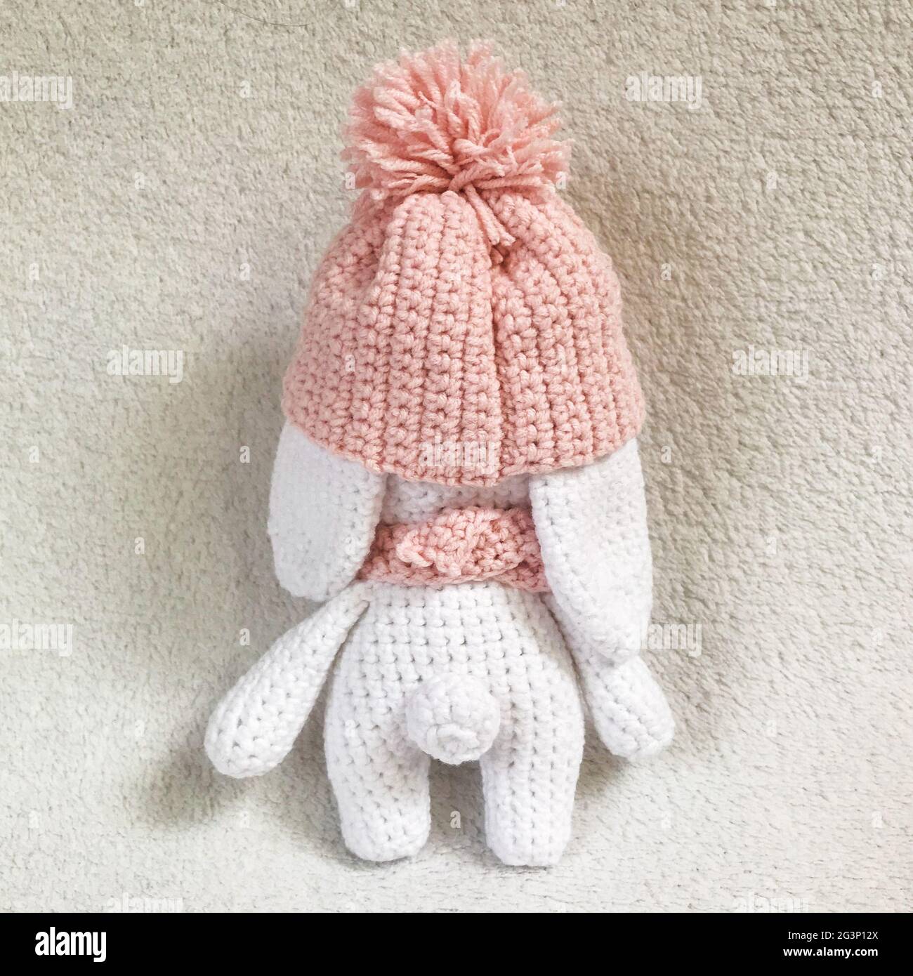 Handmade Crochet Animal Toy - Amigurumi Stuffed Toy - Cute Bunny with a Hat and Scarf Stock Photo