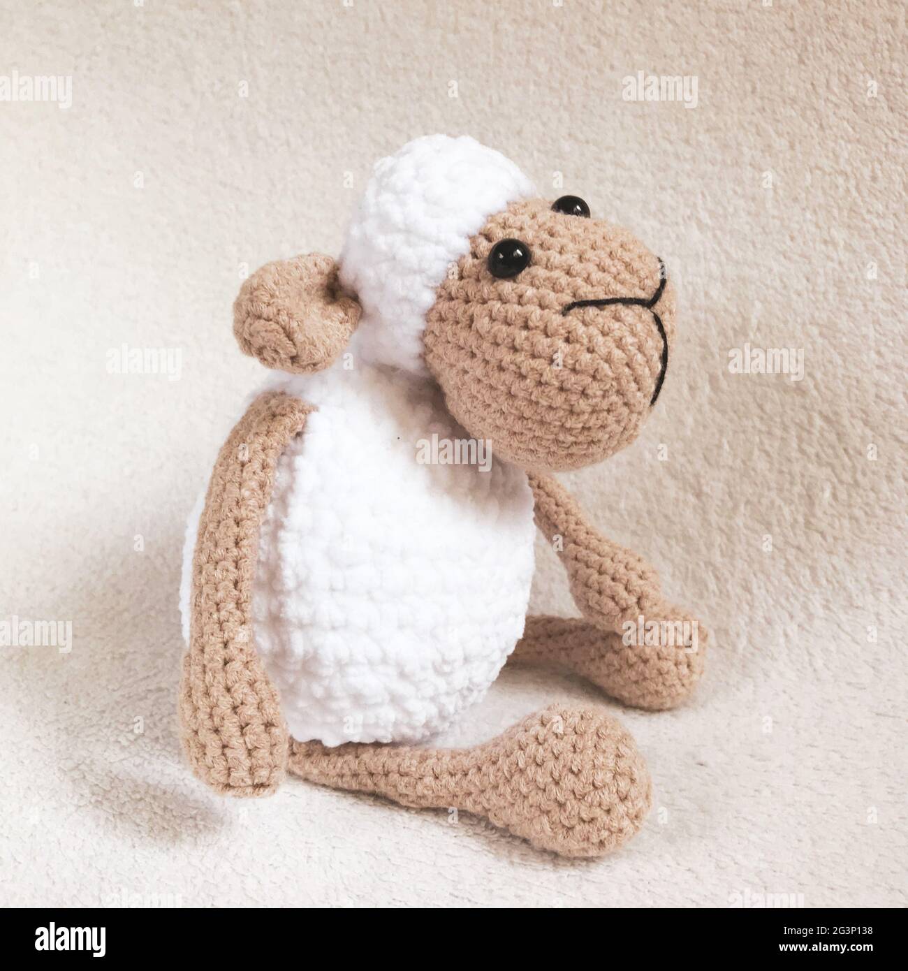 Handmade Crochet Animal Toy - Amigurumi Stuffed Toy - Crochet Sheep Toy Sitting Stock Photo