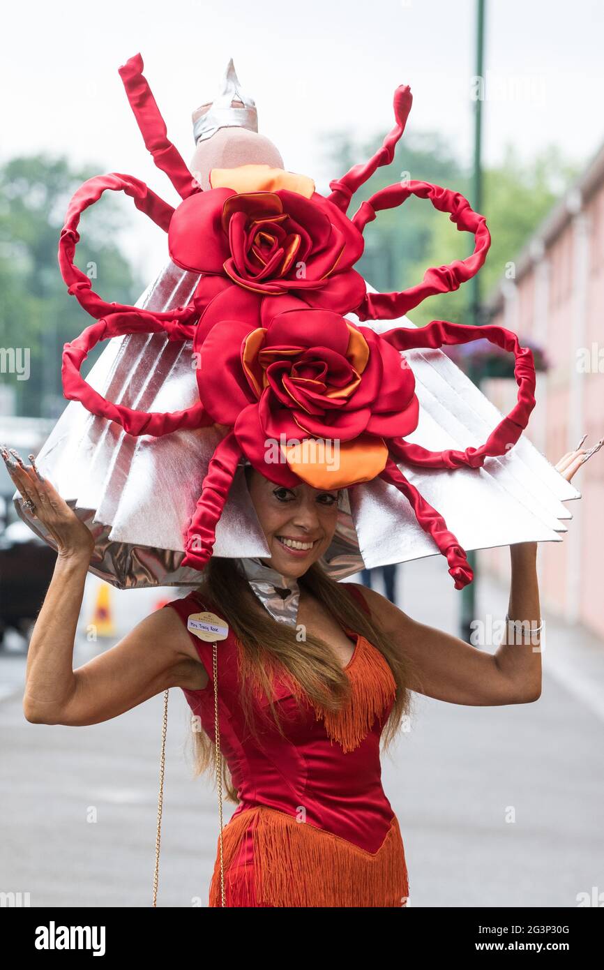 Ascot UK. 17th June 2021. Racegoer Tracy Rose arrives on Ladies Day at Royal Ascot wearing a hat featuring two large red roses. Despite Covid restrictions and changeable weather including some rain