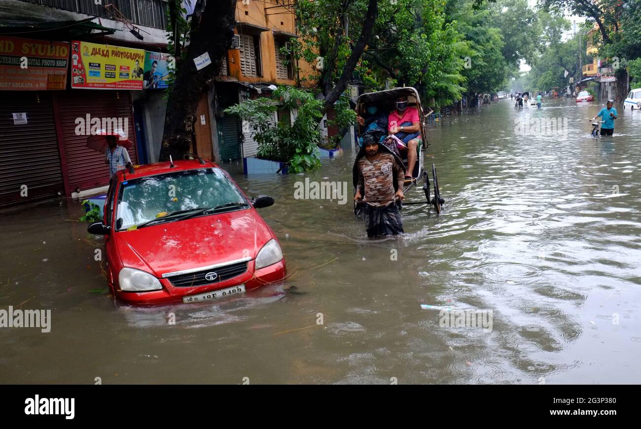 Kolkata, India. 17th June, 2021. Vehicles are seen in a flooded road ...