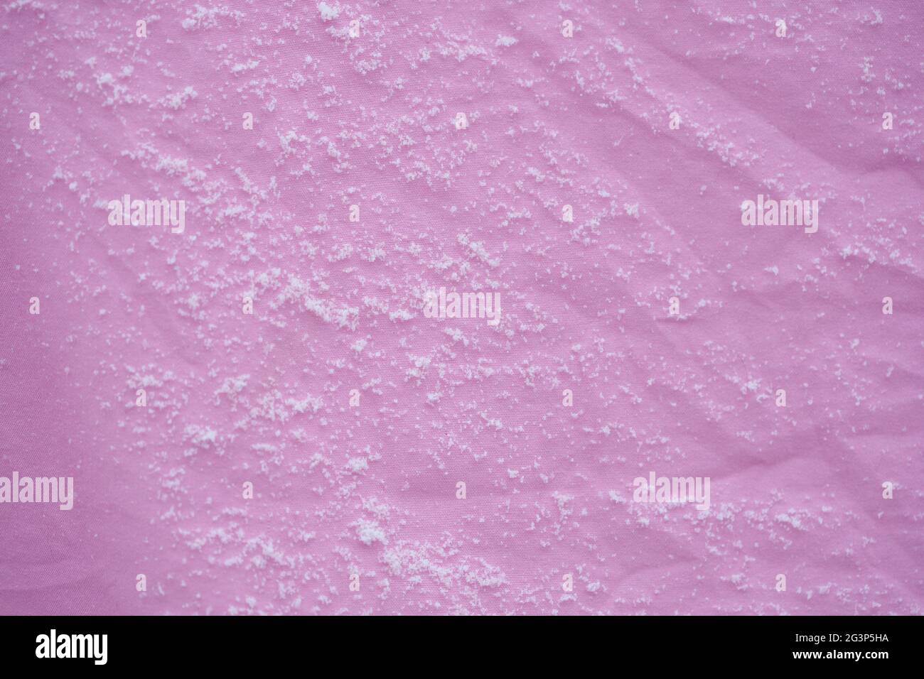 Linen in the cold in winter weather, fresh snow flakes on the texture