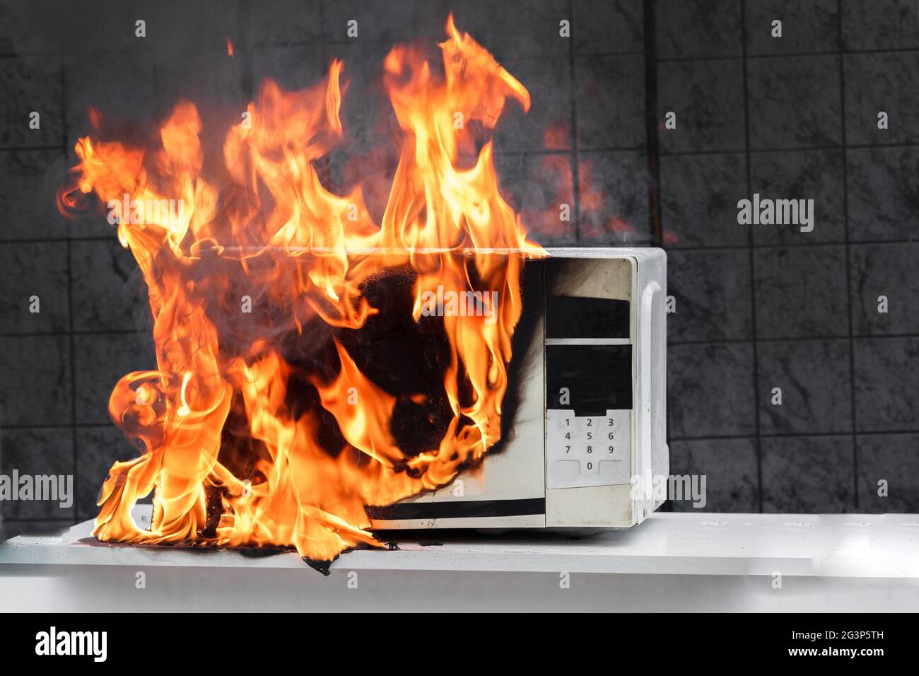 Microwave oven white, in fire front view, electrical appliances caught
