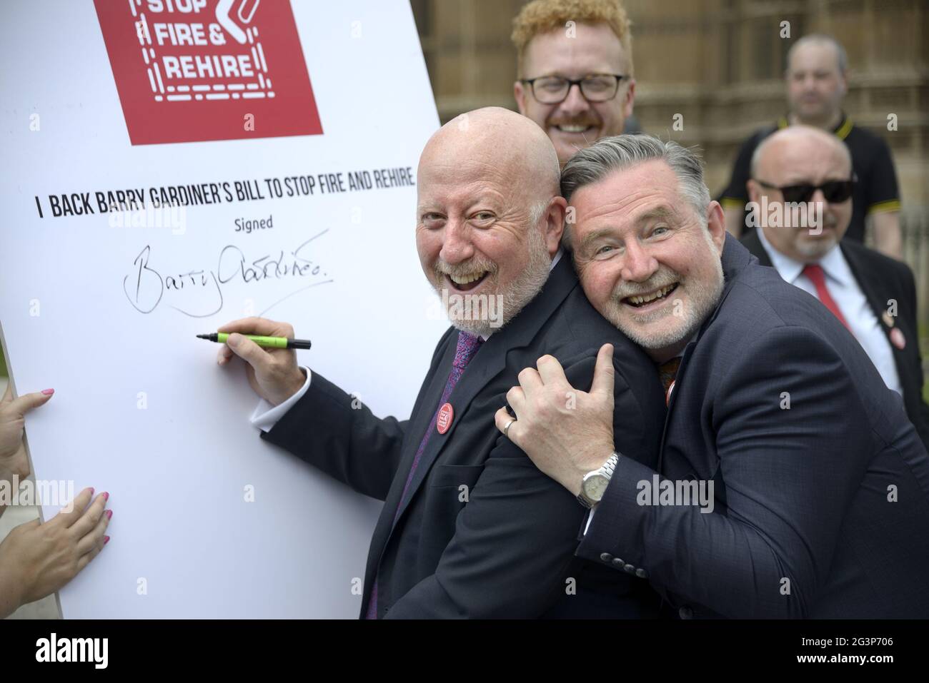 Barry Gardiner MP (Labour, Brent North - right) with Andy McDonald MP (with pen) and Lloyd Russell-Moyle MP (behind) at an event to publicise his priv Stock Photo