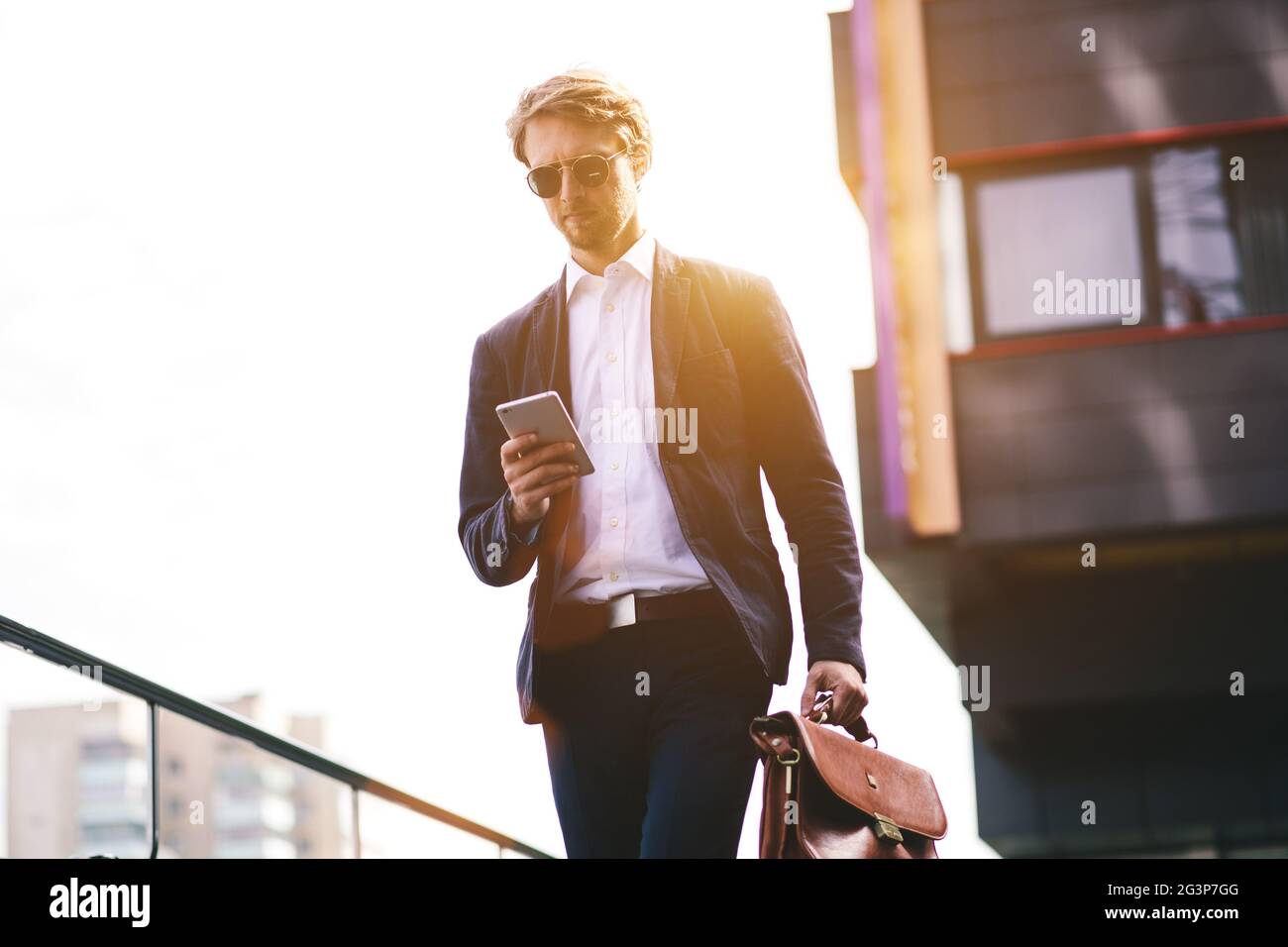 A Businessman Received A Message On His Mobile Phone On His Way To Work Stock Photo