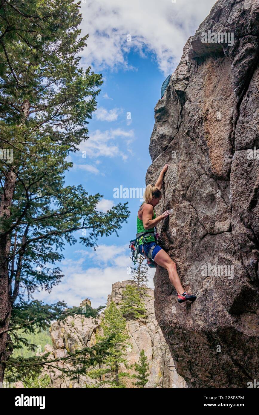 6/6/21 - Boulder, Colorado - A woman works out the moves on a difficult rock climb in Boulder Canyon Stock Photo
