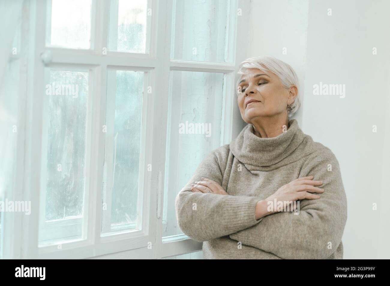 Thoughtful Senior Woman Looking At The Window Stock Photo - Alamy