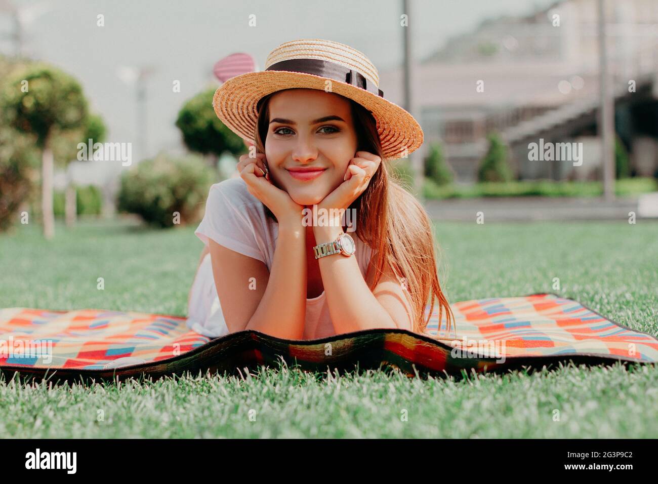Beautiful Young Girl Is Laying On The Blanket In The Park And Smiling