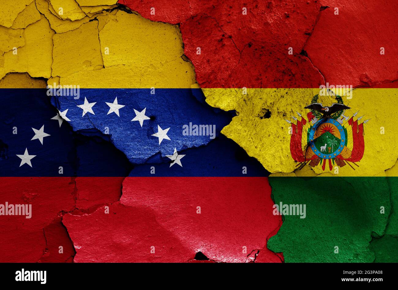 flags of Venezuela and Bolivia painted on cracked wall Stock Photo