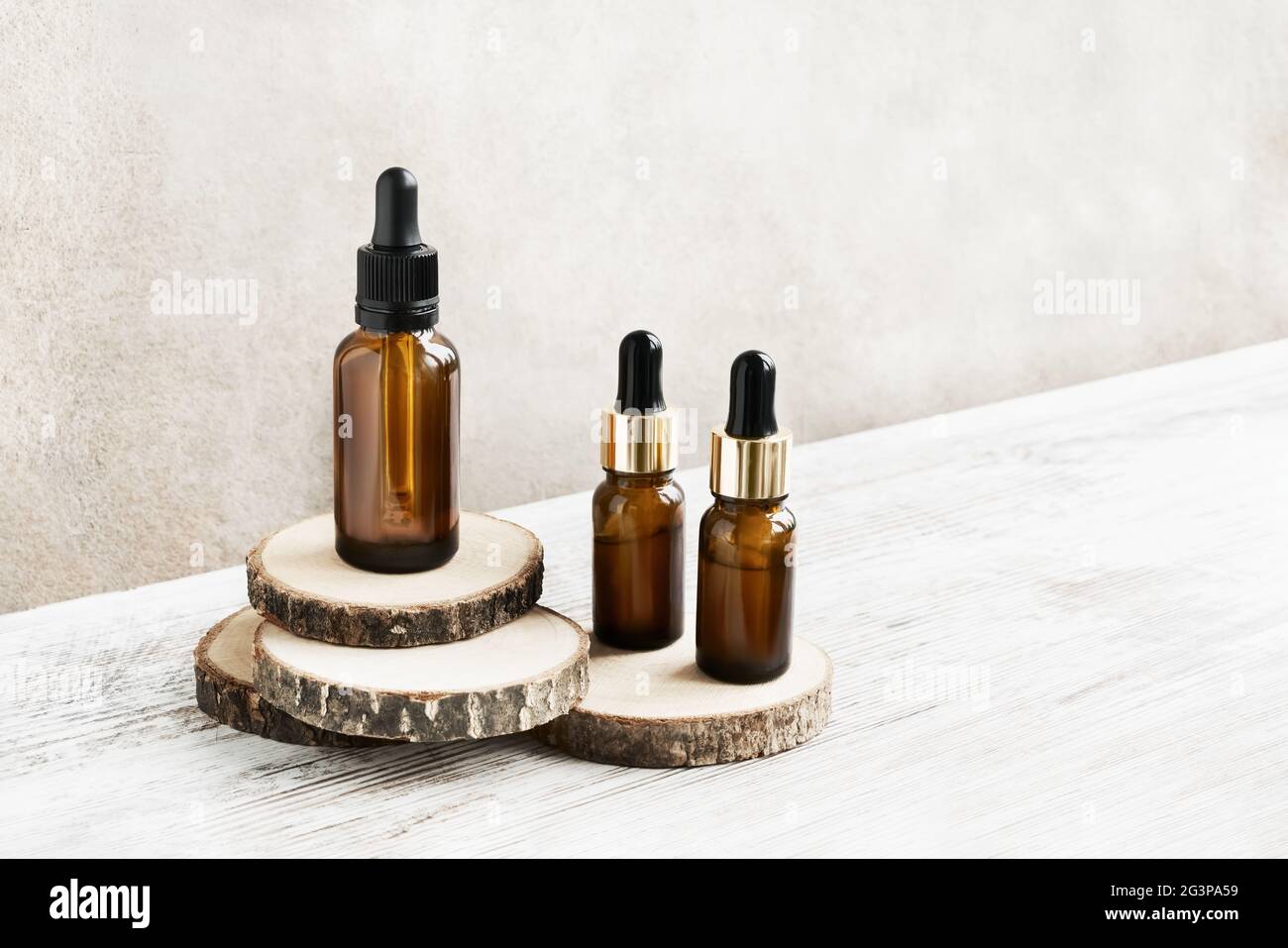 Glass dropper bottles for medical and cosmetic use, for healthy skincare on wooden cut. Natural cosmetic and substantial eco-packaging, SPA concept. Stock Photo