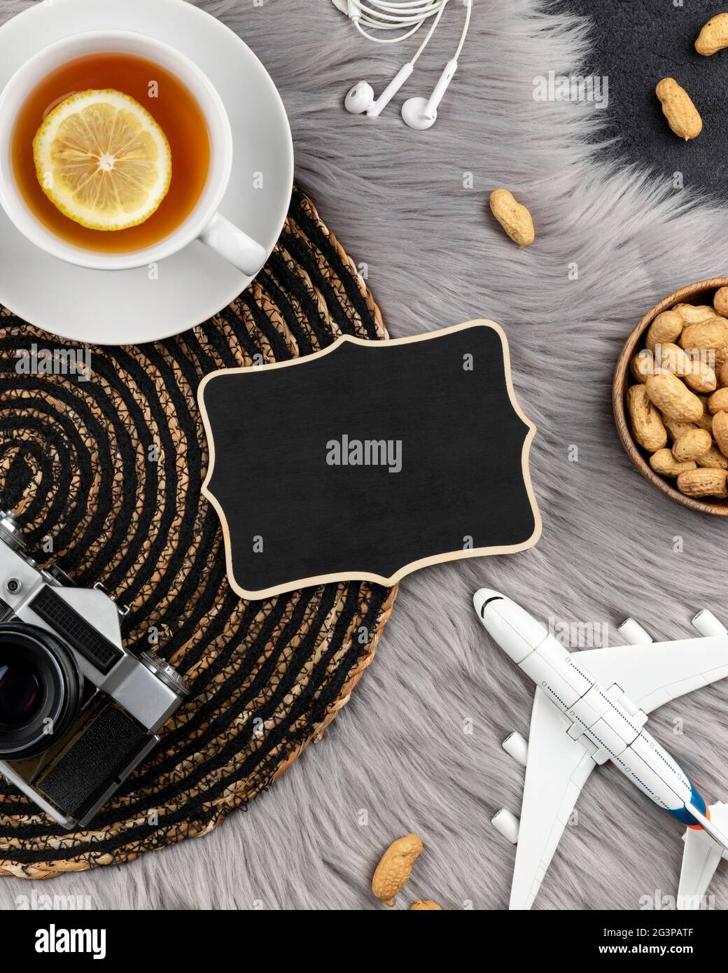 Blank wooden sign with old instant camera plane and tea Stock Photo