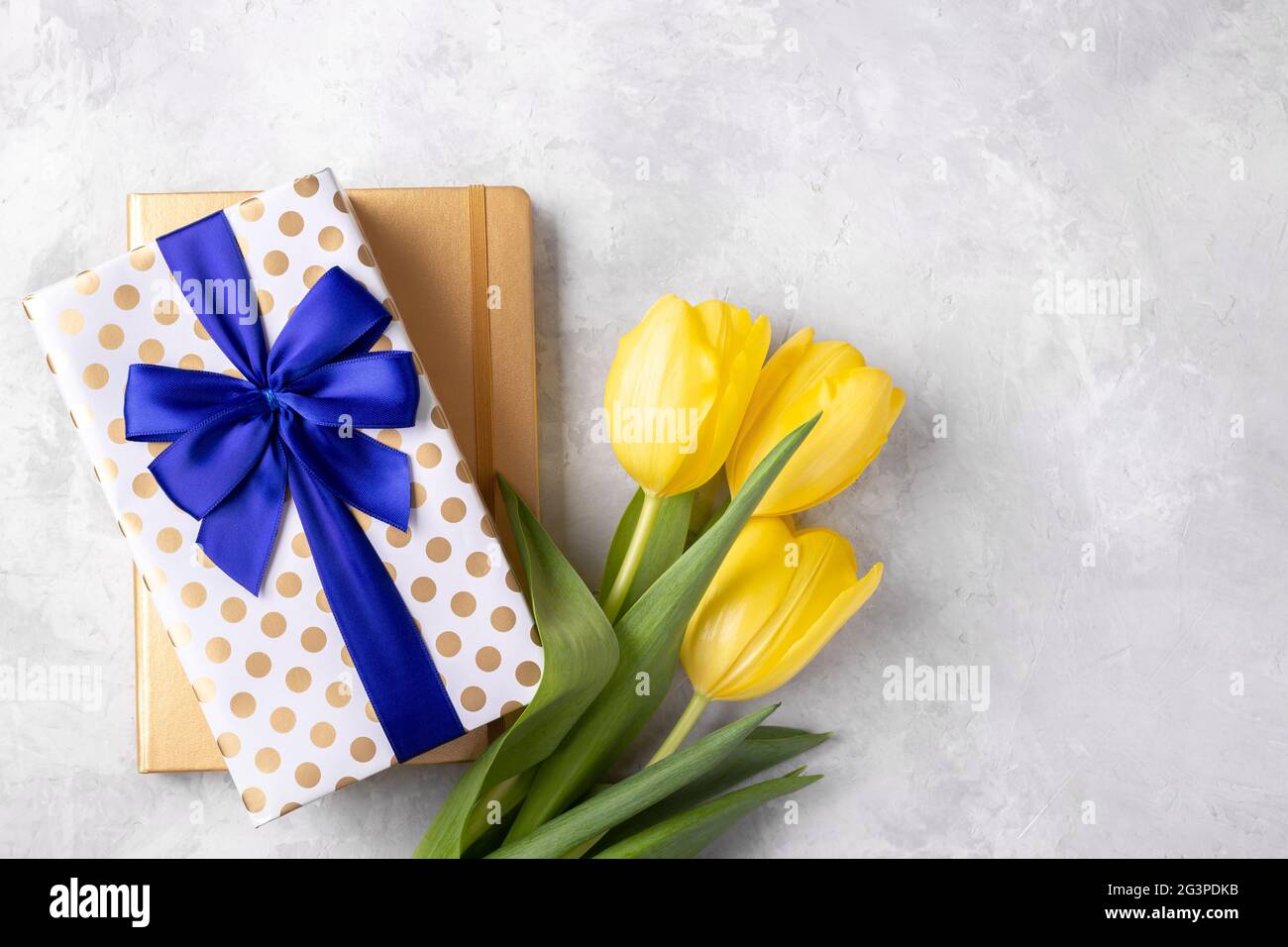 Yellow tulips notepad and gift box Stock Photo - Alamy