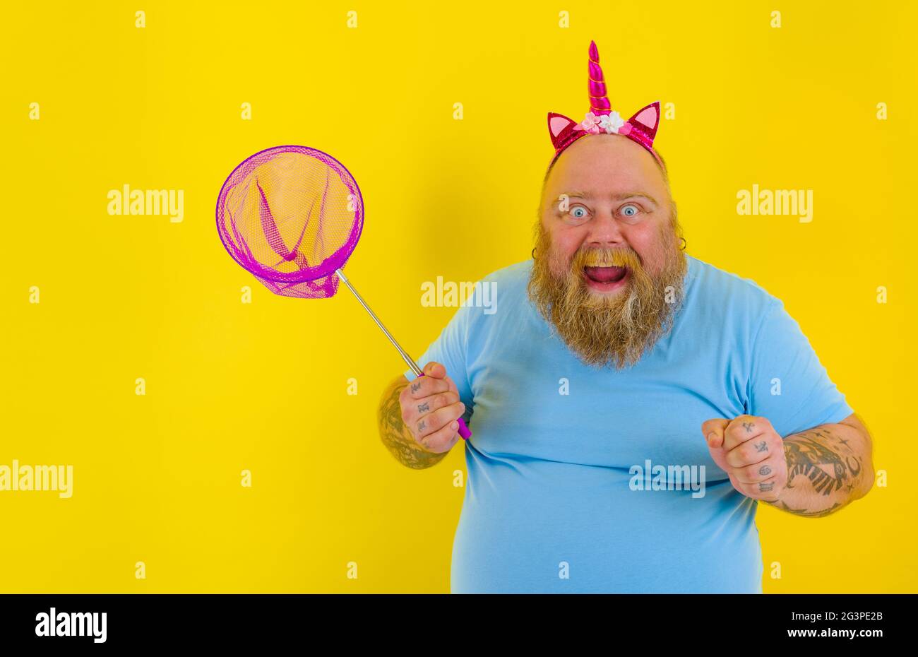 Fat happy man with headband play with sea net Stock Photo