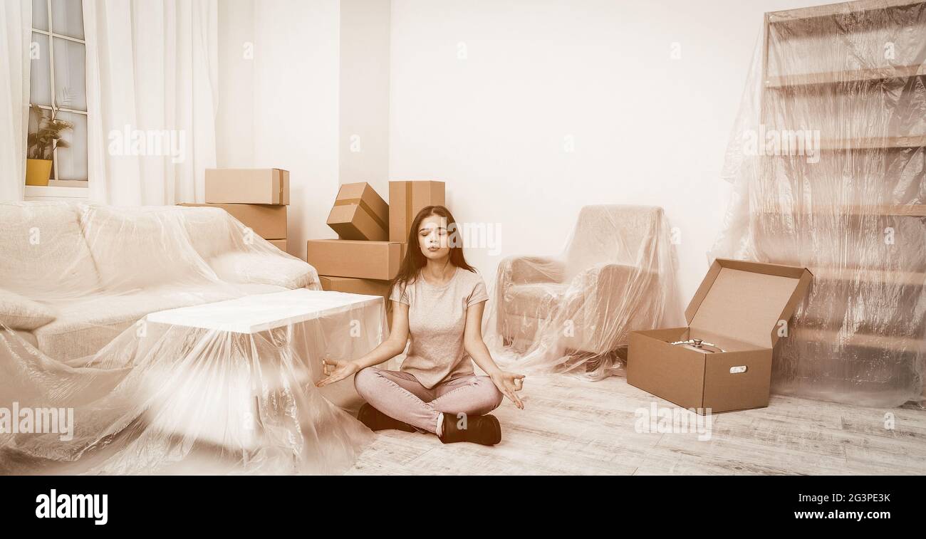 Young hispanic girl meditating or relaxing during the relocation. Stock Photo
