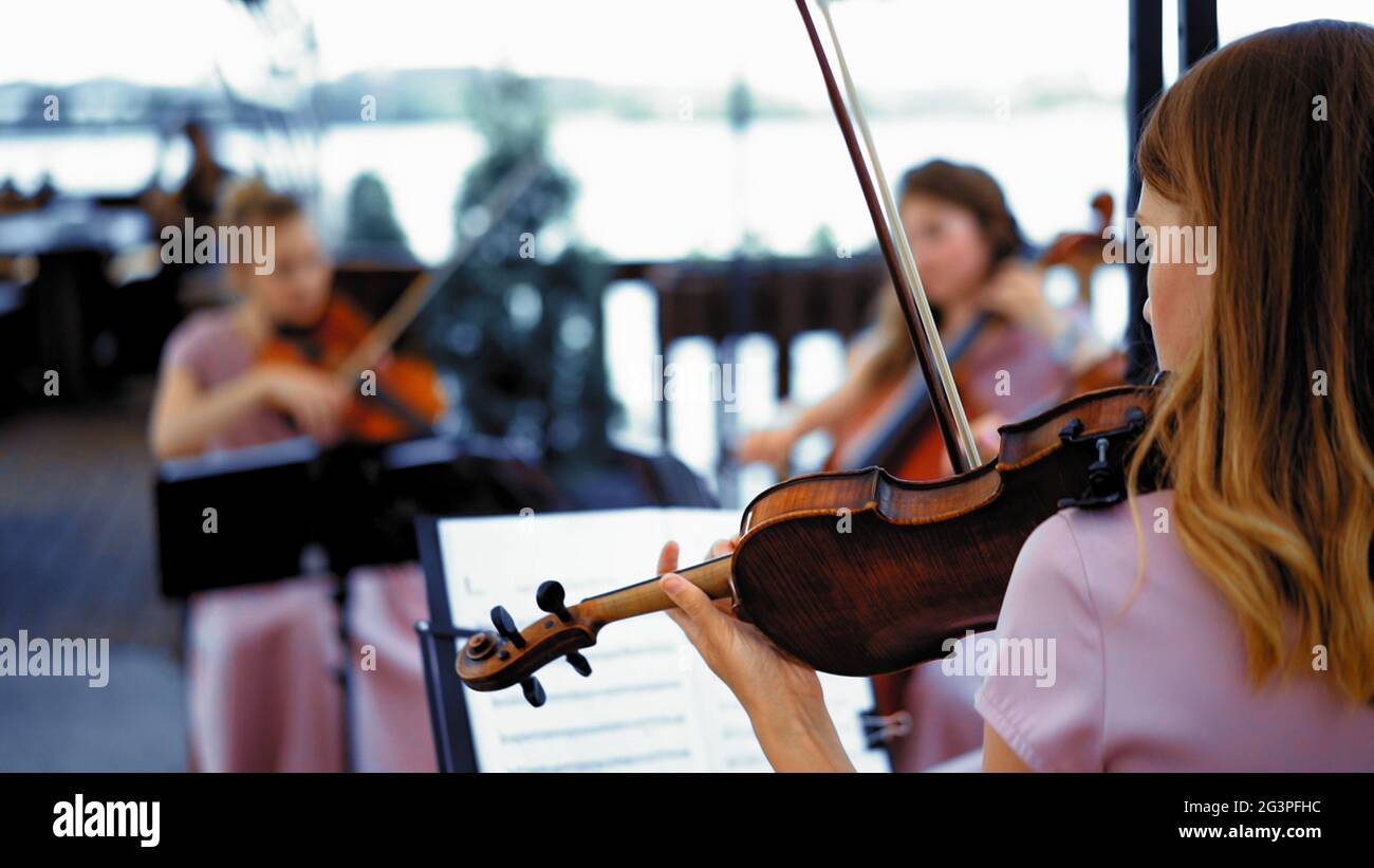 Little Group Of Violinists On The Terrace Stock Photo