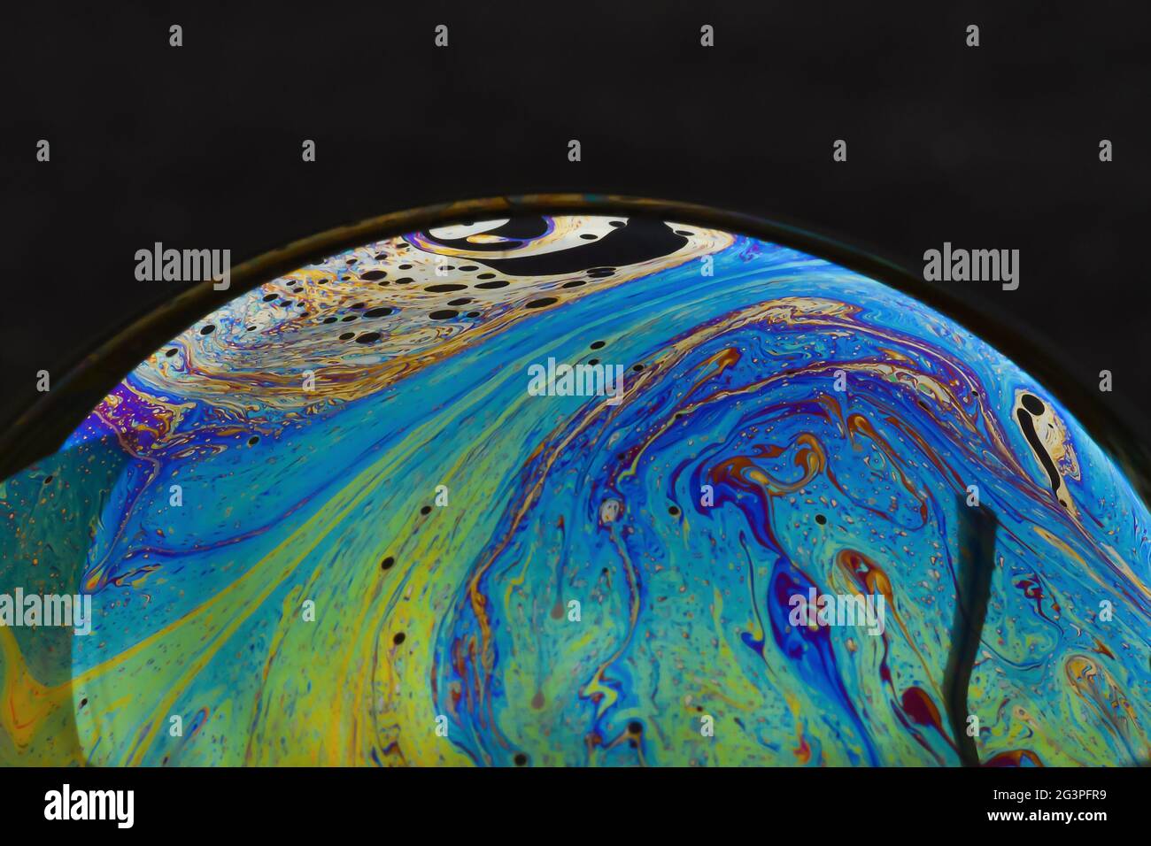 Beautiful psychedelic abstractions on the surface soap bubbles. Stock Photo