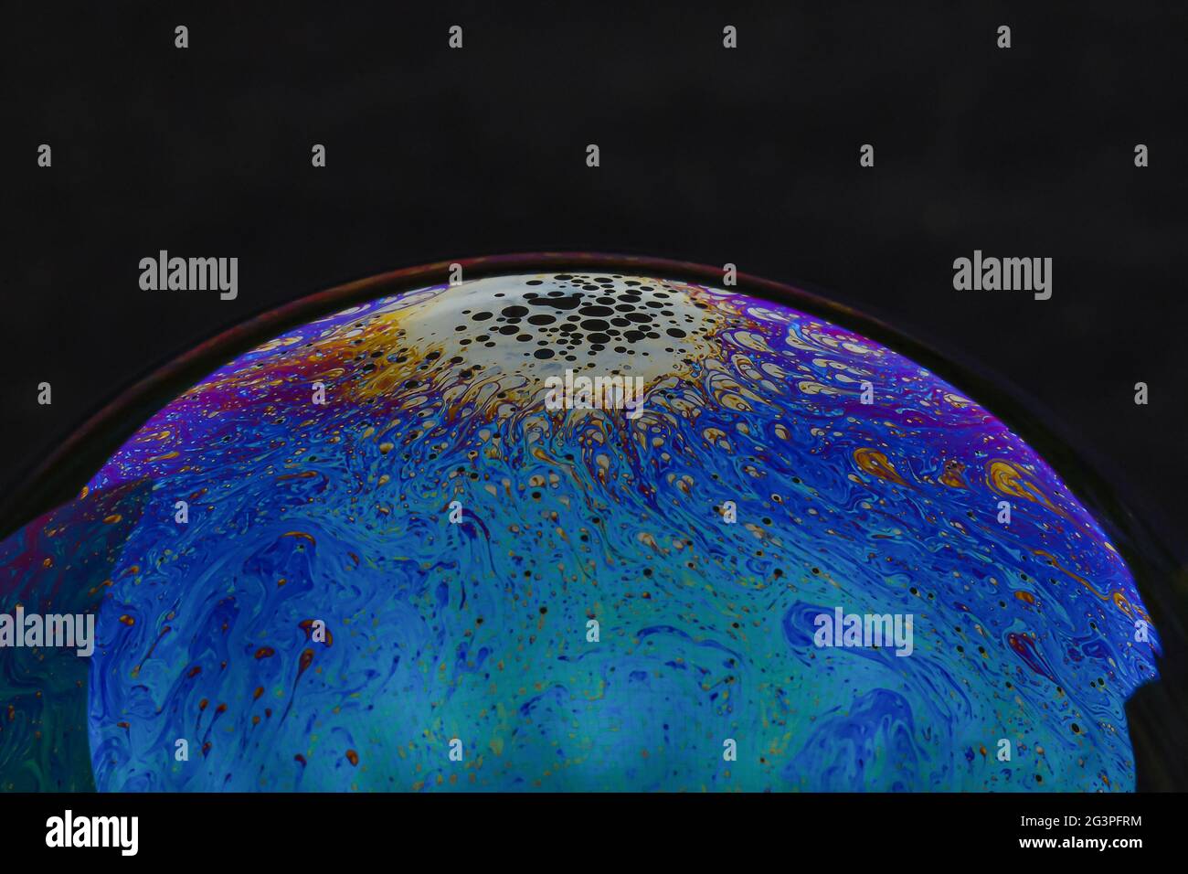 Beautiful psychedelic abstractions on the surface soap bubbles. Stock Photo