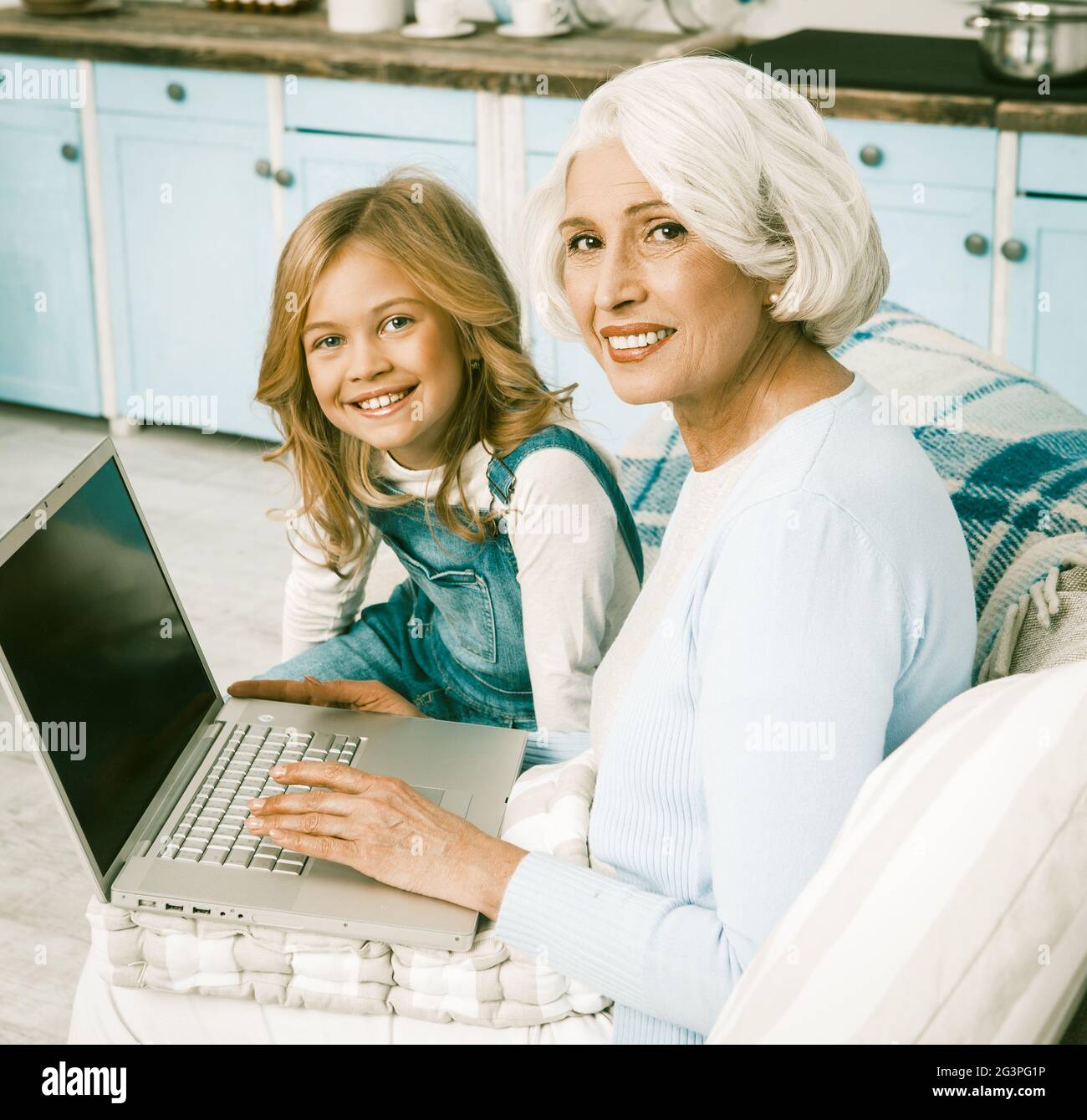 Adorable Granny And Little Girl Using Laptop Stock Photo - Alamy
